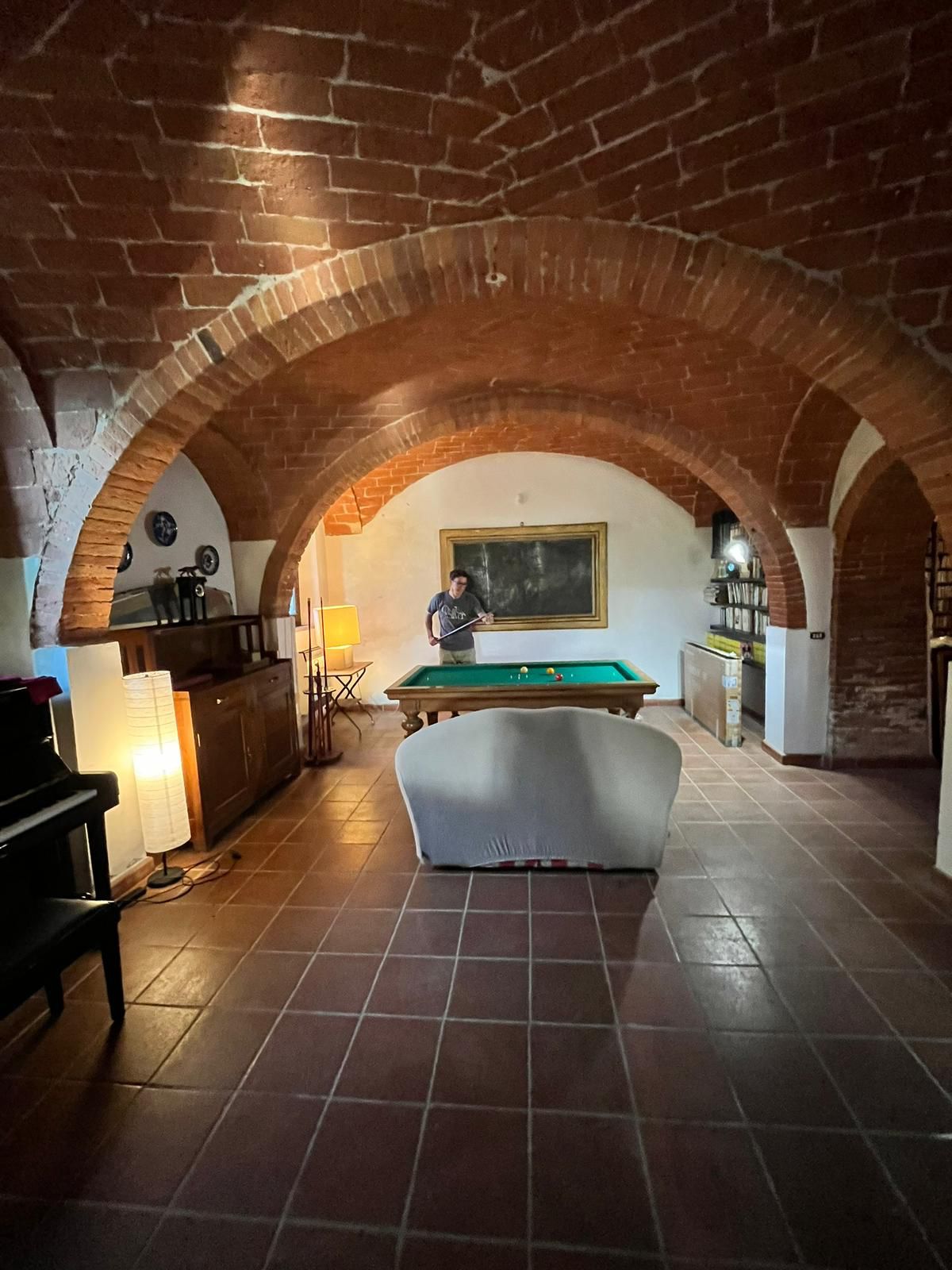 La sala al piano terra con archi in mattoni e biliardo